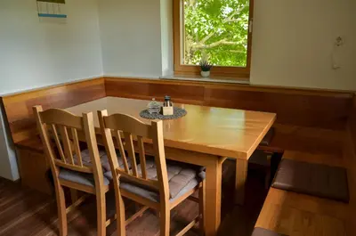 a dining room table with two chairs and a window at Koča v Lozah in Gornji Grad
