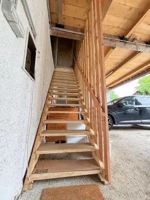 a staircase in a house with a roof at Turistična kmetija Pod kostanji - FarmStay Pod kostanji in Motnik