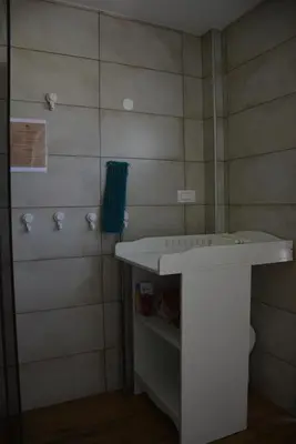 a bathroom with a white sink and a shower at Turistična kmetija Pod kostanji - FarmStay Pod kostanji in Motnik