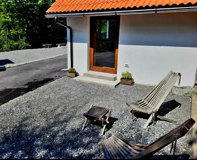 a pair of chairs sitting in front of a house at Bungalov Čuk in Most na Soči