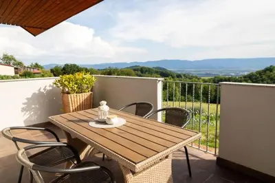a wooden table and chairs on a balcony at Apartment9B with amazing view in Krško