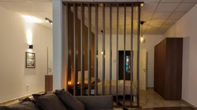 a living room with a couch and a glass wall at Luxury Apartment Simba C in Smarjeske Toplice