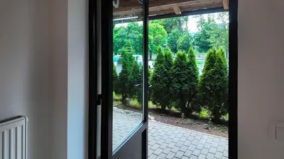a door leading to a garden with trees outside at Luxury Apartment Simba C in Smarjeske Toplice