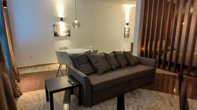 a living room with a couch and a table at Luxury Apartment Simba C in Smarjeske Toplice