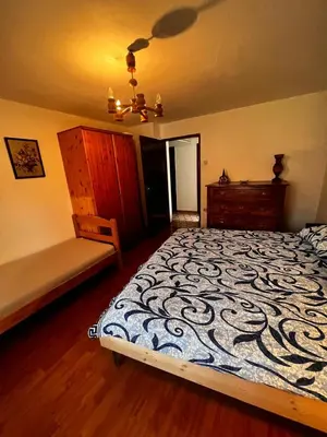 a bedroom with a bed and a bench in it at Apartma Pr'Csrlu