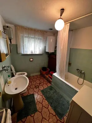 a bathroom with a sink and a toilet and a tub at Apartma Pr'Csrlu