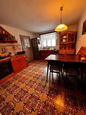 a kitchen with a dining room table and a kitchen with a kitchen at Apartma Pr'Csrlu