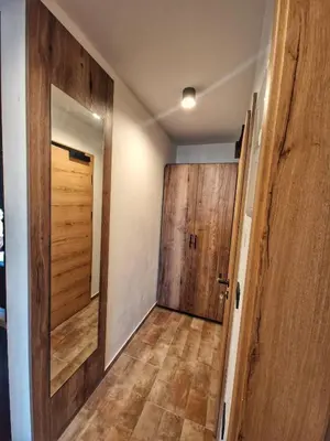 a hallway with a wooden door in a room at Alpine House Mina - Rooms & Apartments in Bled