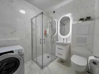 a bathroom with a shower and a toilet and a sink at Designer City Oasis with Garden in Ljubljana