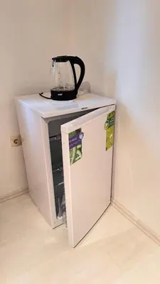 a blender sitting on top of a small refrigerator at Room under Velika planina in Stahovica