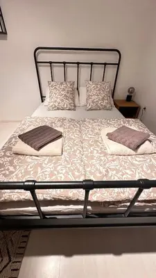 a bed with two pillows on top of it at Room under Velika planina in Stahovica