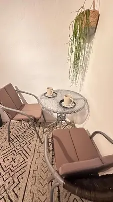 two cups of coffee on a table with chairs at Room under Velika planina in Stahovica