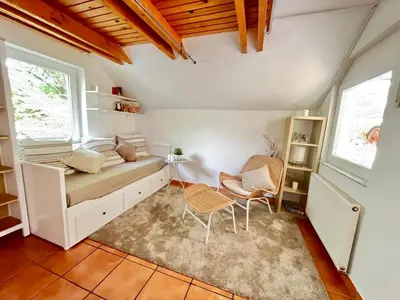 a room with a bed and a table and chairs at Nature and City Access - Perfect Base in Ljubljana in Ljubljana