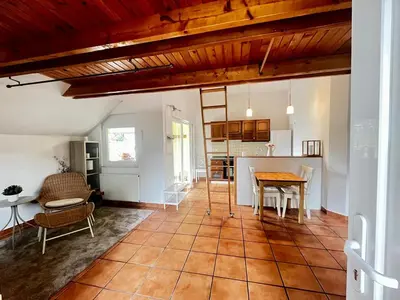 a living room with a table and a kitchen at Nature and City Access - Perfect Base in Ljubljana in Ljubljana