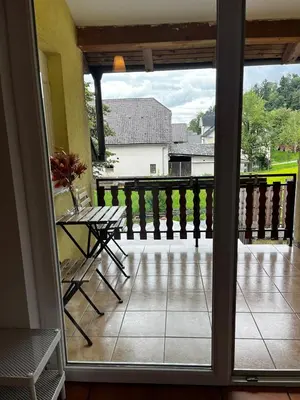 a view of a porch with a table and a balcony at Nature and City Access - Perfect Base in Ljubljana in Ljubljana