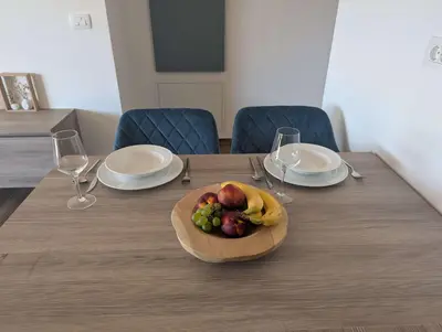 a wooden table with a plate of fruit on it at Štuhecova domačija