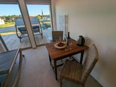 a dining room with a table with a bowl of fruit on it at Štuhecova domačija