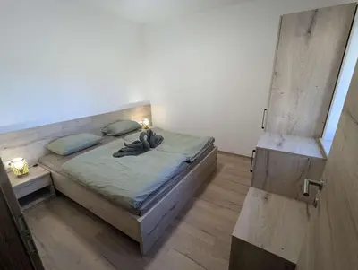 a bedroom with a bed with a wooden floor at Štuhecova domačija