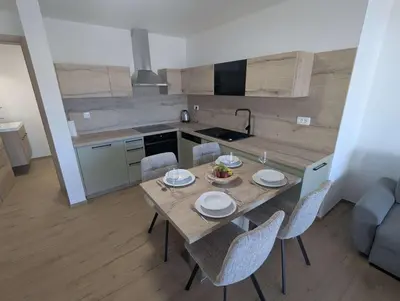 a kitchen and dining room with a table and chairs at Štuhecova domačija