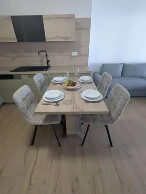 a wooden table with chairs and a bowl of food on it at Štuhecova domačija