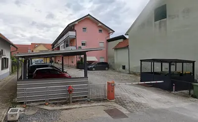 a bus stop in a parking lot next to a building at Studio AK in Žalec