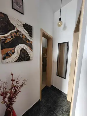 a hallway with a painting on the wall and a mirror at Studio AK in Žalec