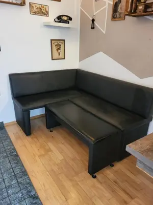 a bench in the corner of a room at Studio AK in Žalec