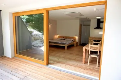 a view of a room with a bed and a table at Bled Forest Apartment in Bled