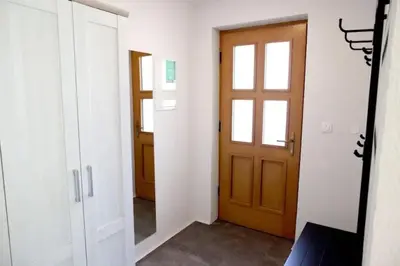 an empty hallway with a door and a window at Bled Forest Apartment in Bled