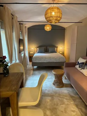 a bedroom with a bed and a couch at Vida's homes in Ljubljana