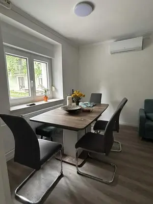 a dining room with a wooden table and chairs at Apartment Tonc in Kobarid