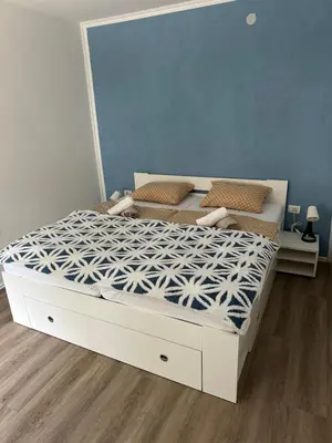 a bedroom with a bed with a white bed frame at Apartment Tonc in Kobarid