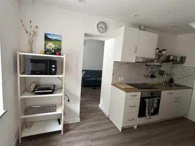 a kitchen with white cabinets and a counter top at Apartment Tonc in Kobarid