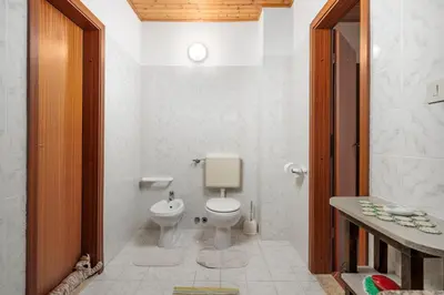 a bathroom with a toilet and a sink at Ranč Katja in Abdul in Materija