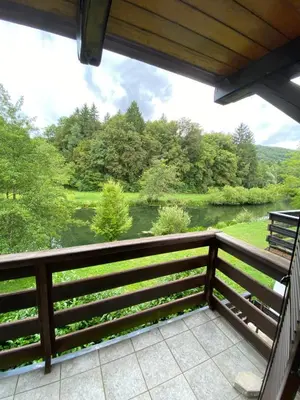 a balcony with a view of a river at Retreat House River Krka - Hiša oddiha reka Krka in Krka
