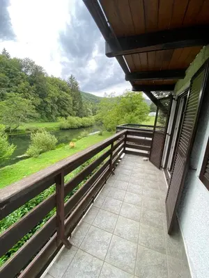 a balcony of a house with a view of a river at Retreat House River Krka - Hiša oddiha reka Krka in Krka