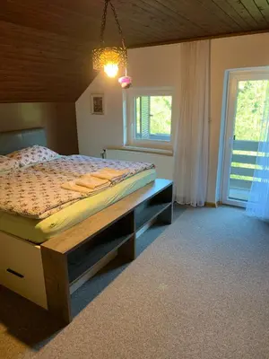 a bedroom with a bed in a room with a window at Retreat House River Krka - Hiša oddiha reka Krka in Krka
