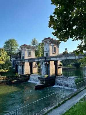 a bridge over a river with a waterfall at Cukr in Ljubljana