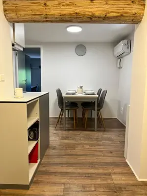 a kitchen and dining room with a table and chairs at Cukr in Ljubljana