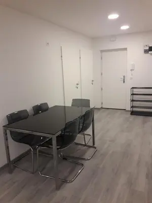 a conference room with a glass table and chairs at Apartment Emona Ljubljana in Ljubljana
