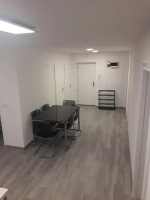 an empty room with a table and chairs in it at Apartment Emona Ljubljana in Ljubljana