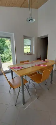a table and chairs in a room with a table at Počitniška hiška v grapi in Tolmin