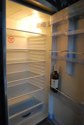 a refrigerator with a bottle of wine in it at Apartment Center 25 in Ljubljana
