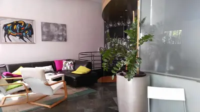 a living room with a couch and a potted plant at Apartment Center 25 in Ljubljana