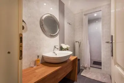 a bathroom with a white sink and a mirror at Apartment Center 25 in Ljubljana