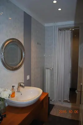 a bathroom with a white sink and a shower at Apartment Center 25 in Ljubljana