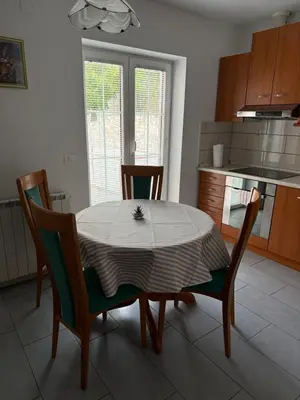 a table and chairs in a kitchen with a table and a table at House Mohar in Lokev