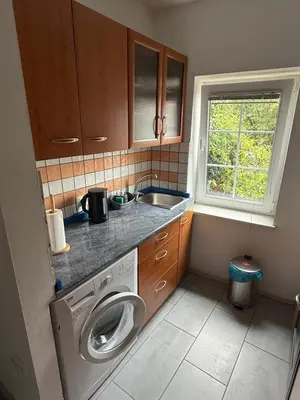 a small kitchen with a washing machine and a sink at House Mohar in Lokev