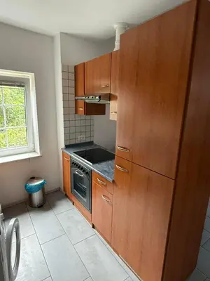 a kitchen with wooden cabinets and a stove at House Mohar in Lokev