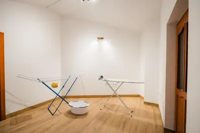 a room with two glass tables and a white wall at Spacious Apartment Senozece - with terrace & grill in Senožeče